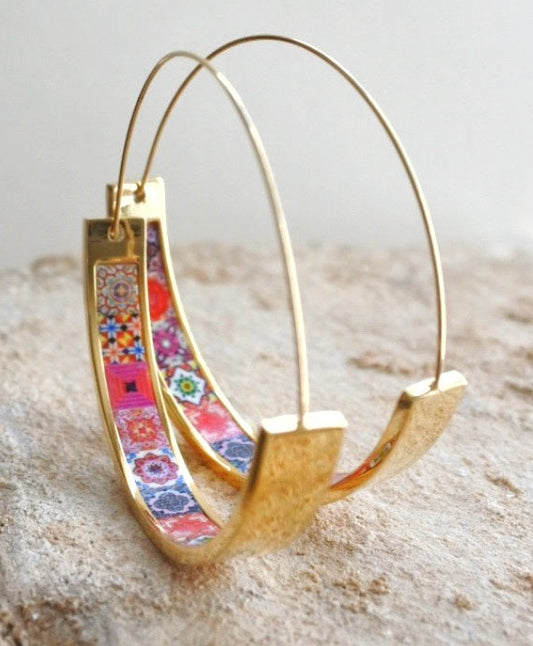 Gold stainless steel hoops with a flat bottom and a red tile inlay. They measure 1.75”